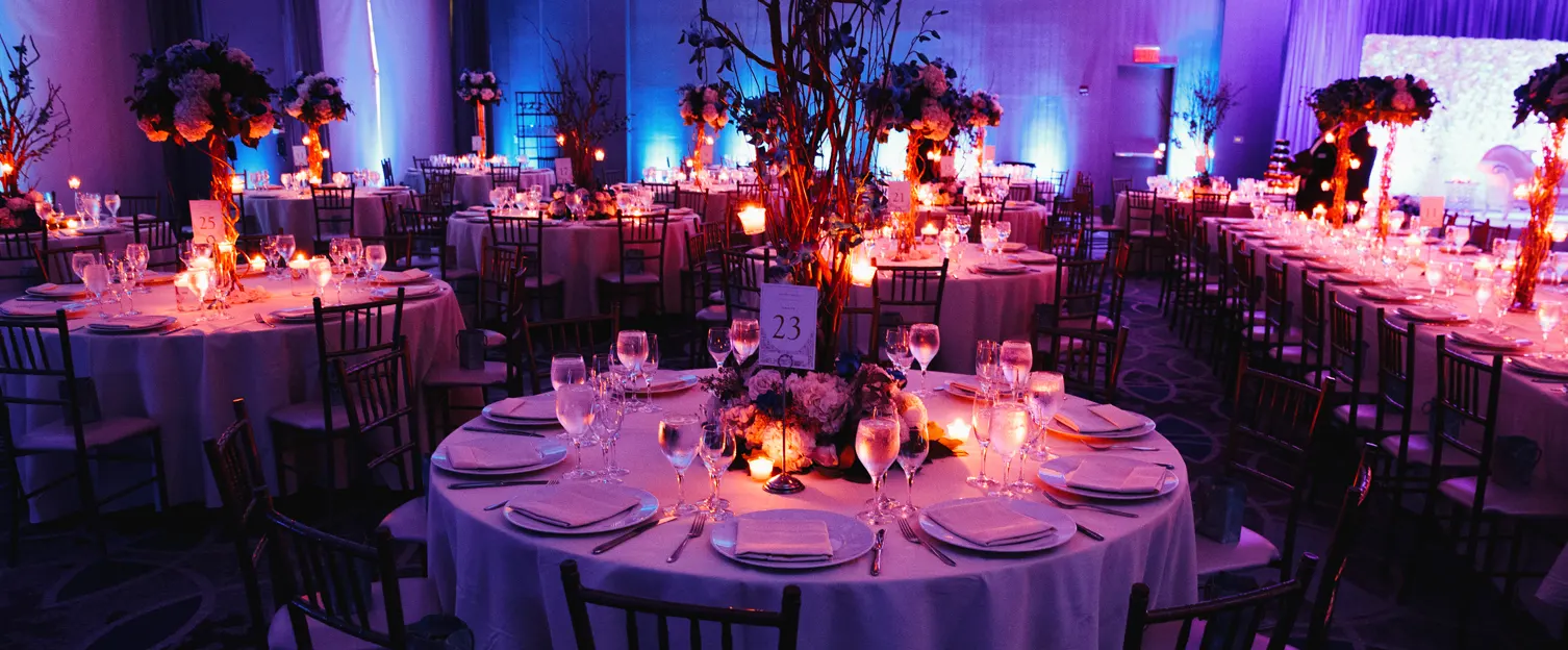 decorated-wedding-hall-with-candles-round-tables-centerpieces